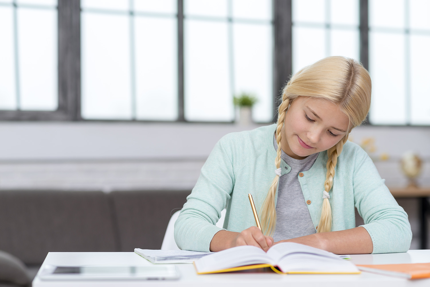 young-blonde-student-taking-notes-from-lesson.jpg