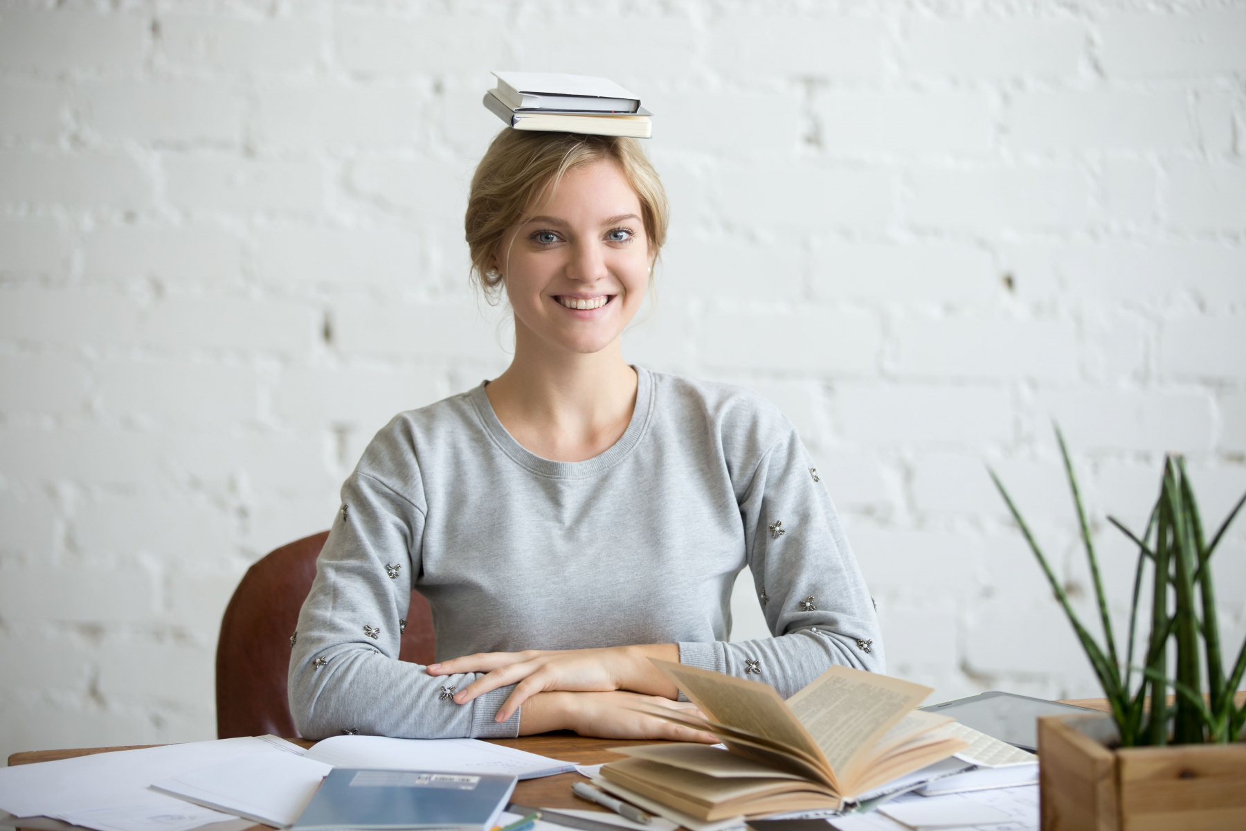 portrait-of-smiling-woman-at-desk-books-on-her-head.jpg portrait-of-smiling-woman-at-desk-books-on-her-head.jpg