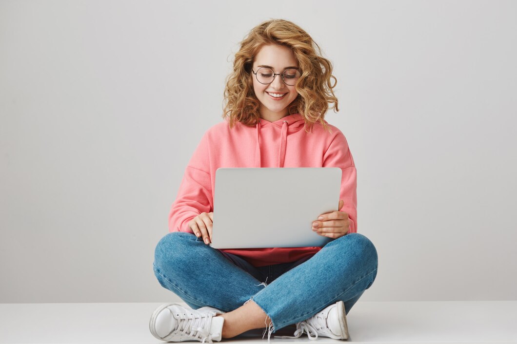 smiling-female-student-writing-essay-sitting-with-laptop-floor_176420-20218.jpg
