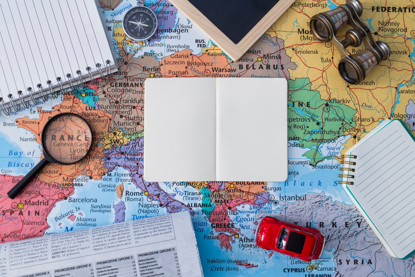 travel-elements-composition-with-open-book_23-2147981831.jpg