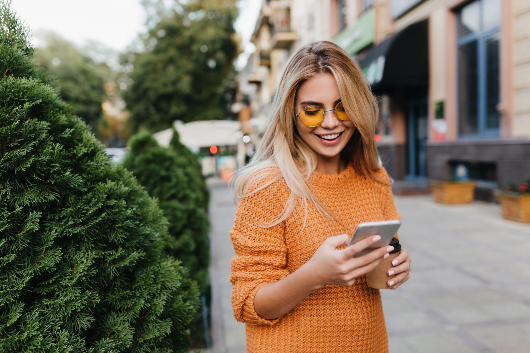lovely-blonde-woman-walking-by-green-bushes-with-smile-carrying-smartphone-cup-coffee.jpg lovely-blonde-woman-walking-by-green-bushes-with-smile-carrying-smartphone-cup-coffee.jpg